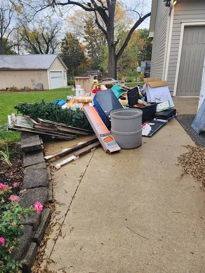 Dumpster being loaded with debris for Residential Dumpster Rental in Fair Lakes